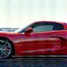 Sports car loaded onto transport trailer.